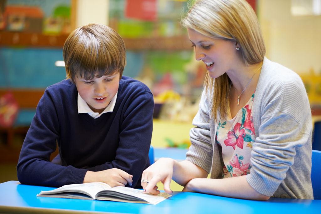 teacher reading with student