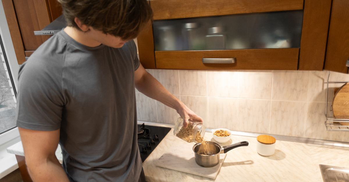 teen ager boy working in kitchen