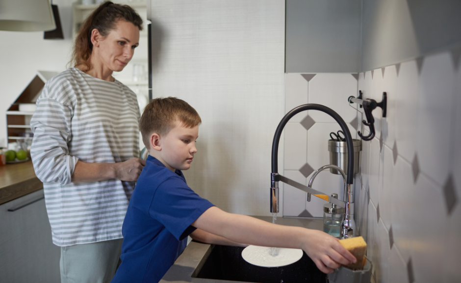 boy helping with chores in kitchen