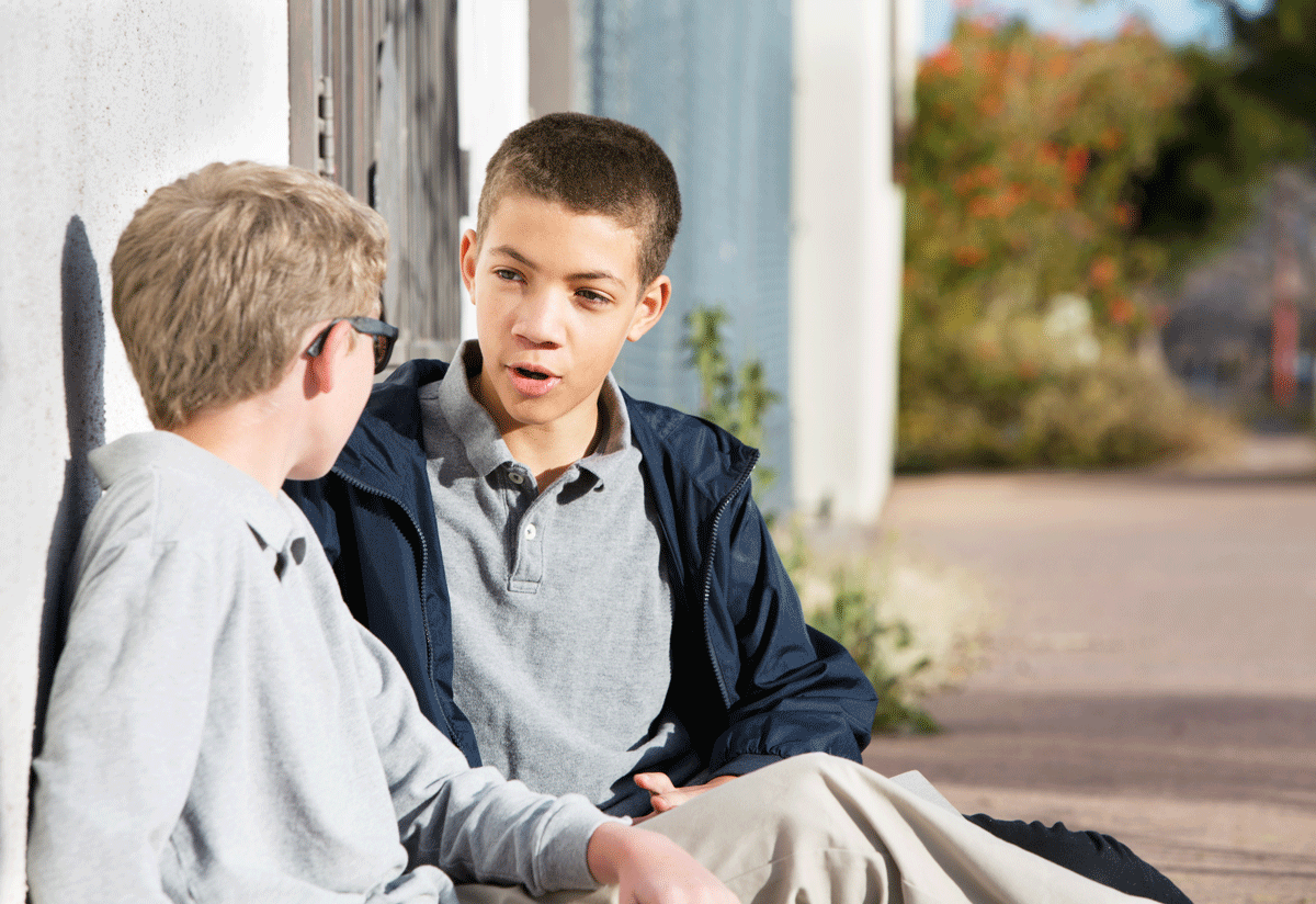 Young teen students talking to friend outside