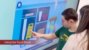 student using touchscreen in special needs school